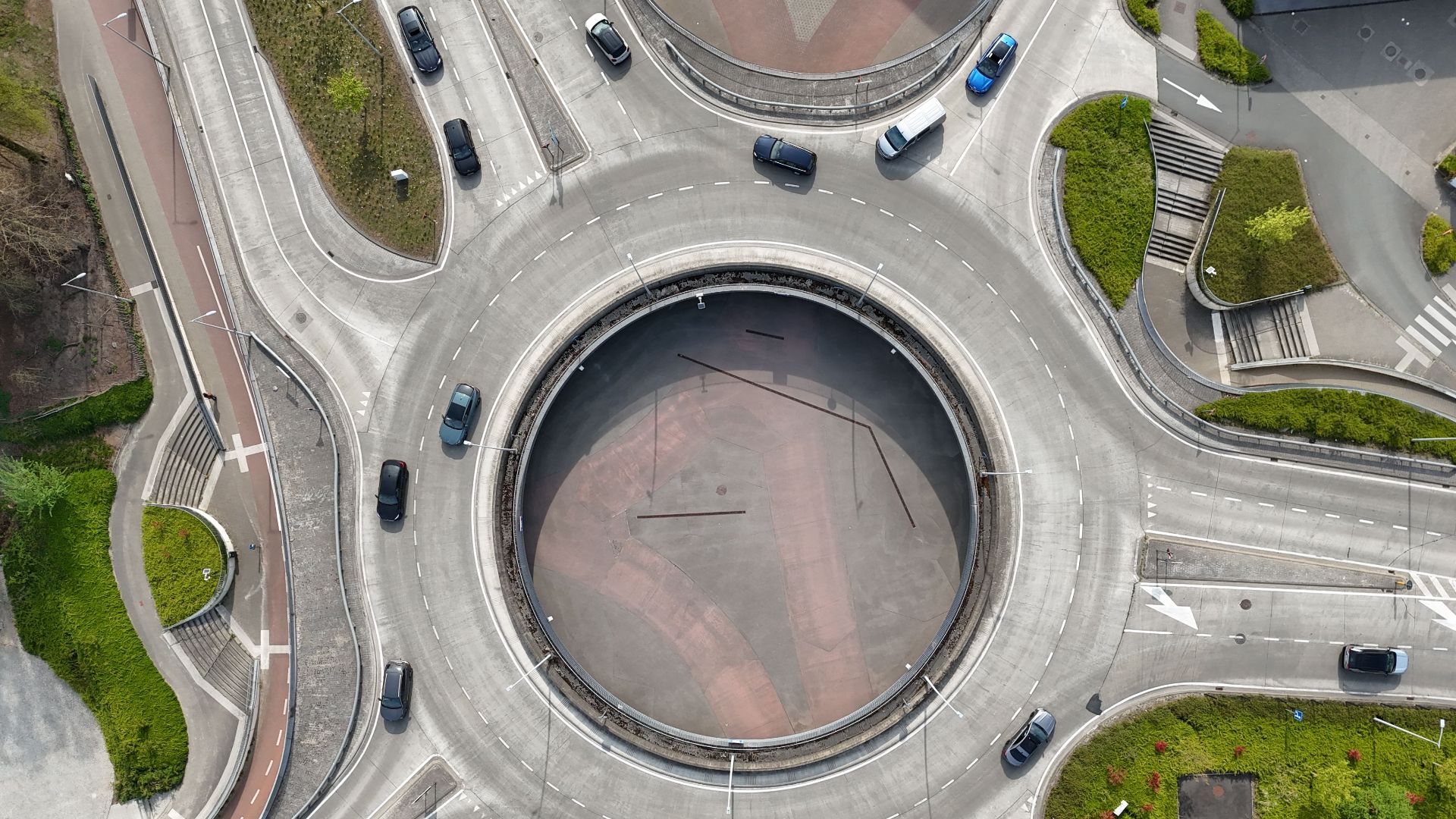 Aerial shot of a traffic roundabout in Bruges, Belgium, showcasing urban planning and transportation design.