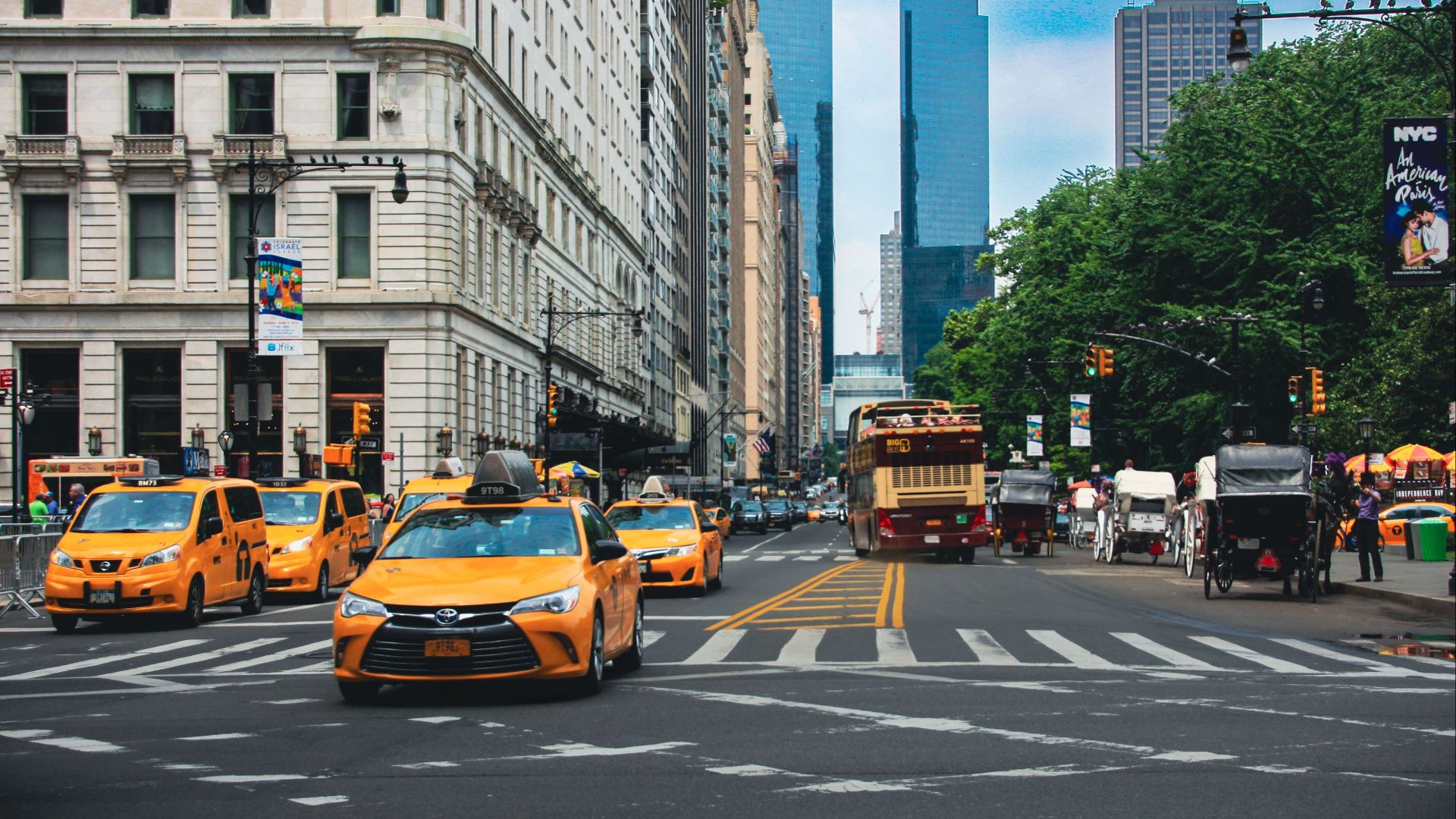 Yellow taxis and bustling traffic on a vibrant New York City street.