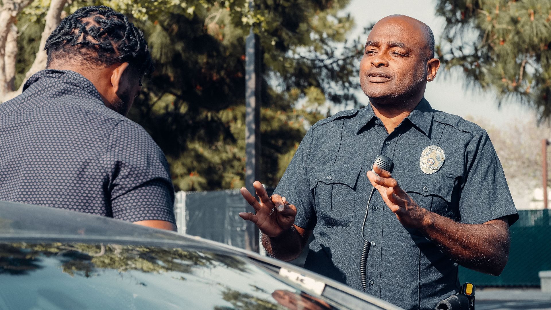 A police officer engages in conversation outdoors, reflecting community service and law enforcement.