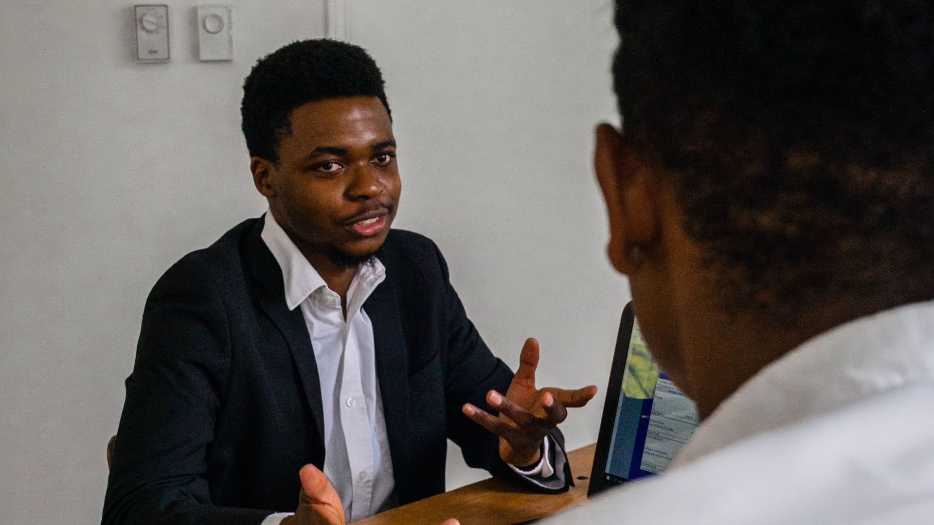 Two professionals engaging in a focused discussion during a business meeting.