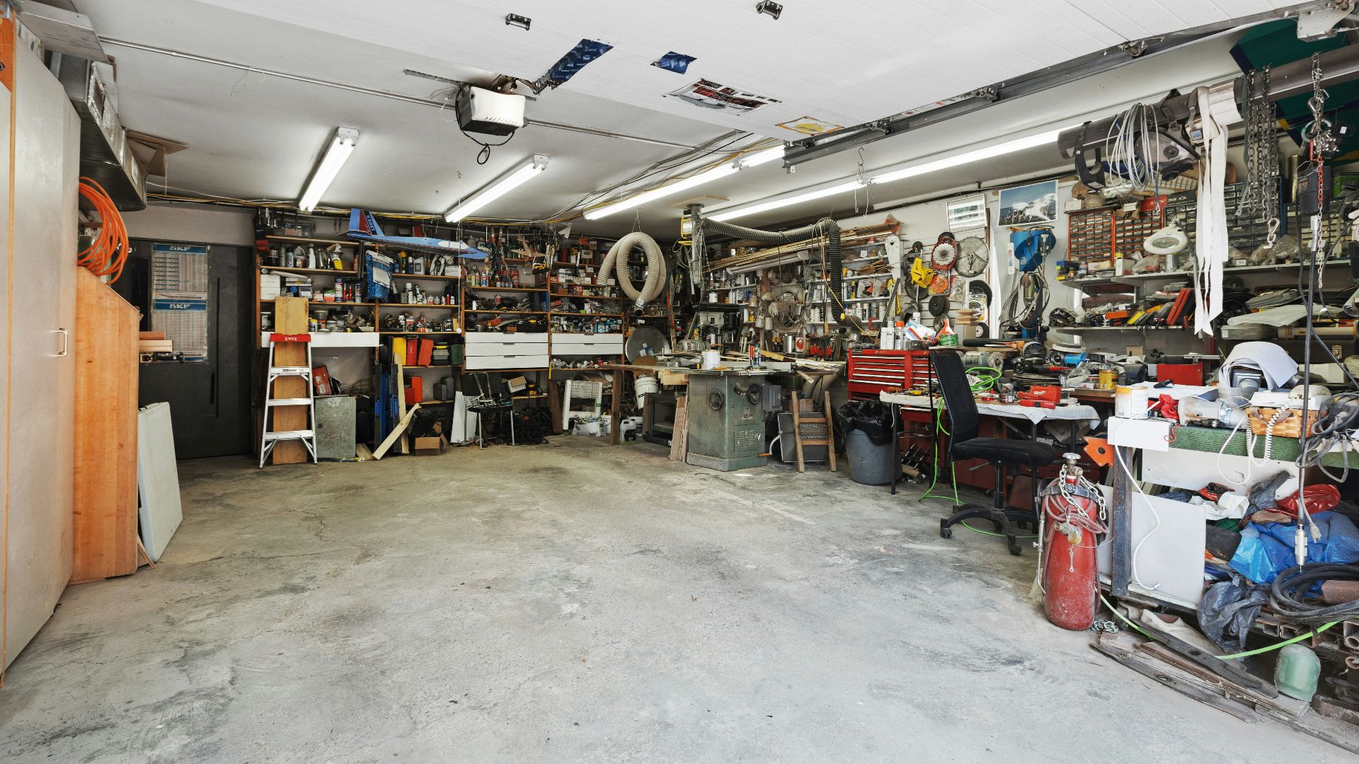 a garage filled with lots of clutter and tools