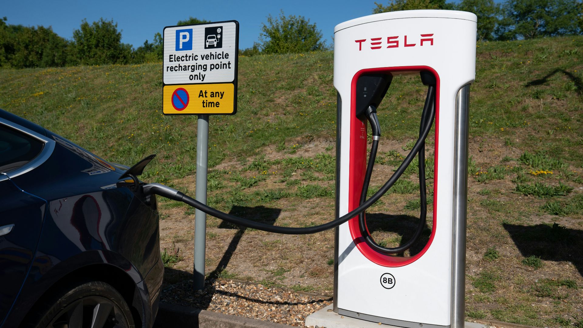 Tesla charging station with electric car connected.