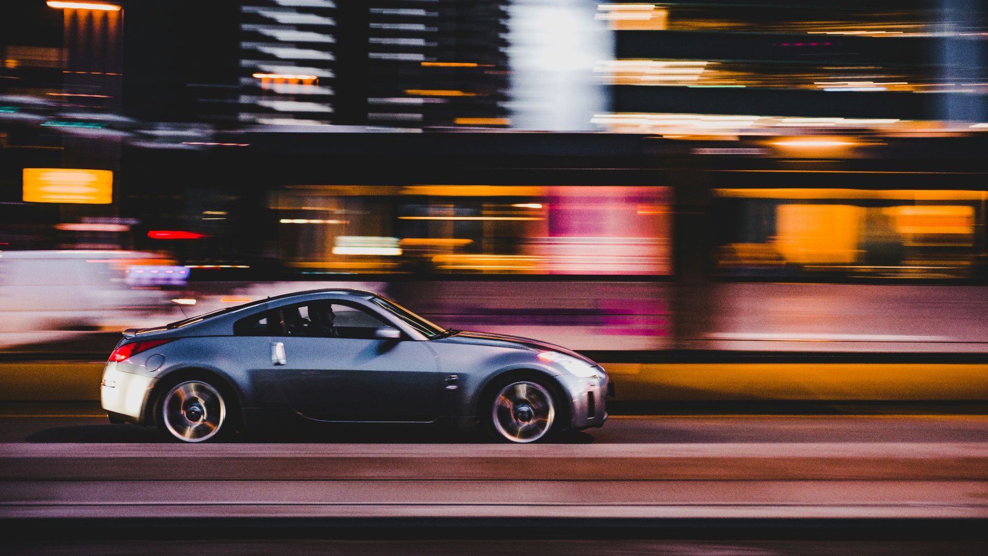panning photography of gray coupe on road