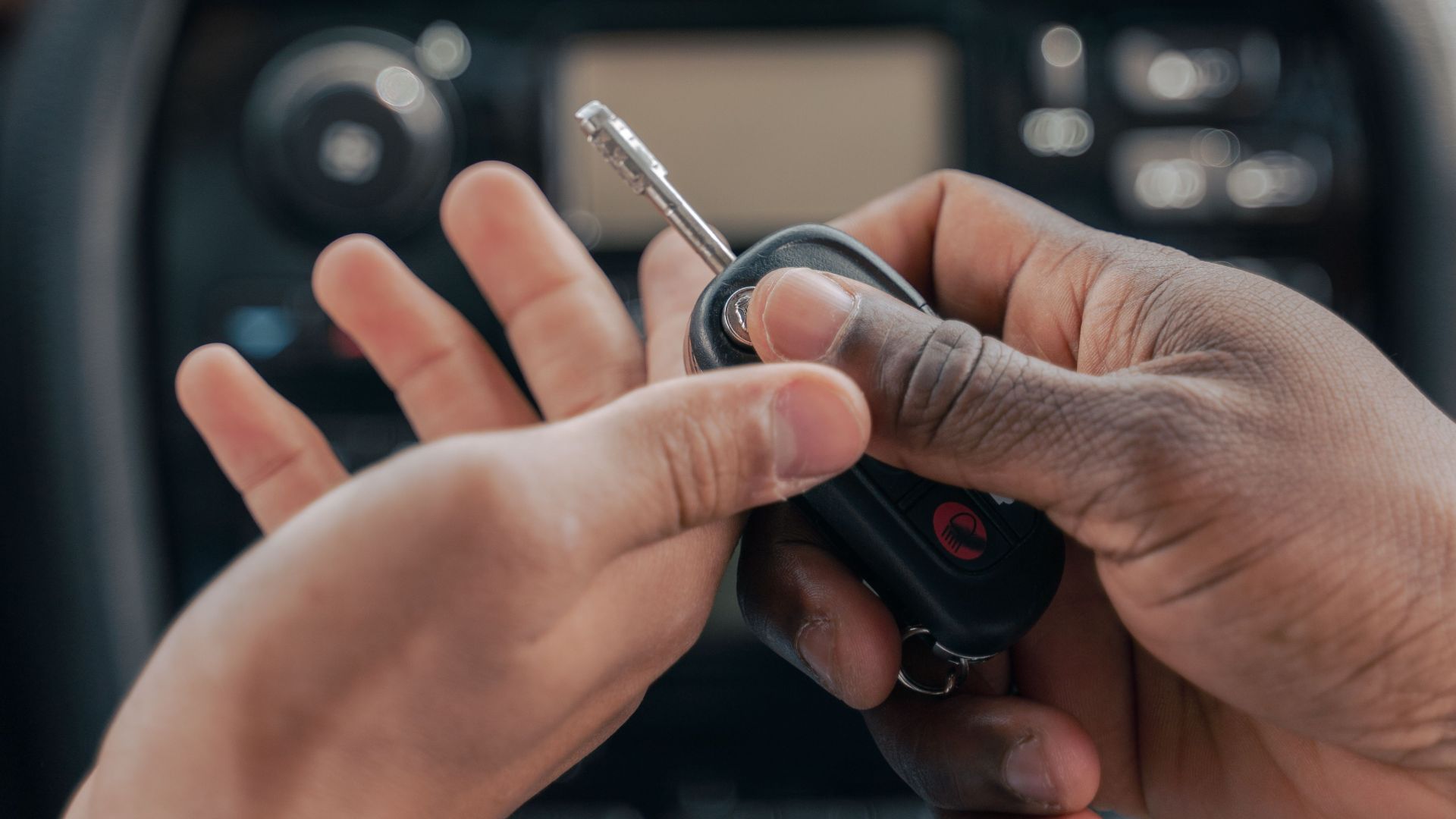 Two people exchanging car keys inside a luxury car, emphasizing guidance and learning.