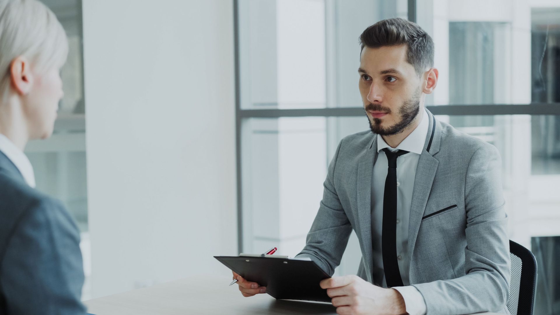 Two business professionals engaged in a meeting in a modern office environment.