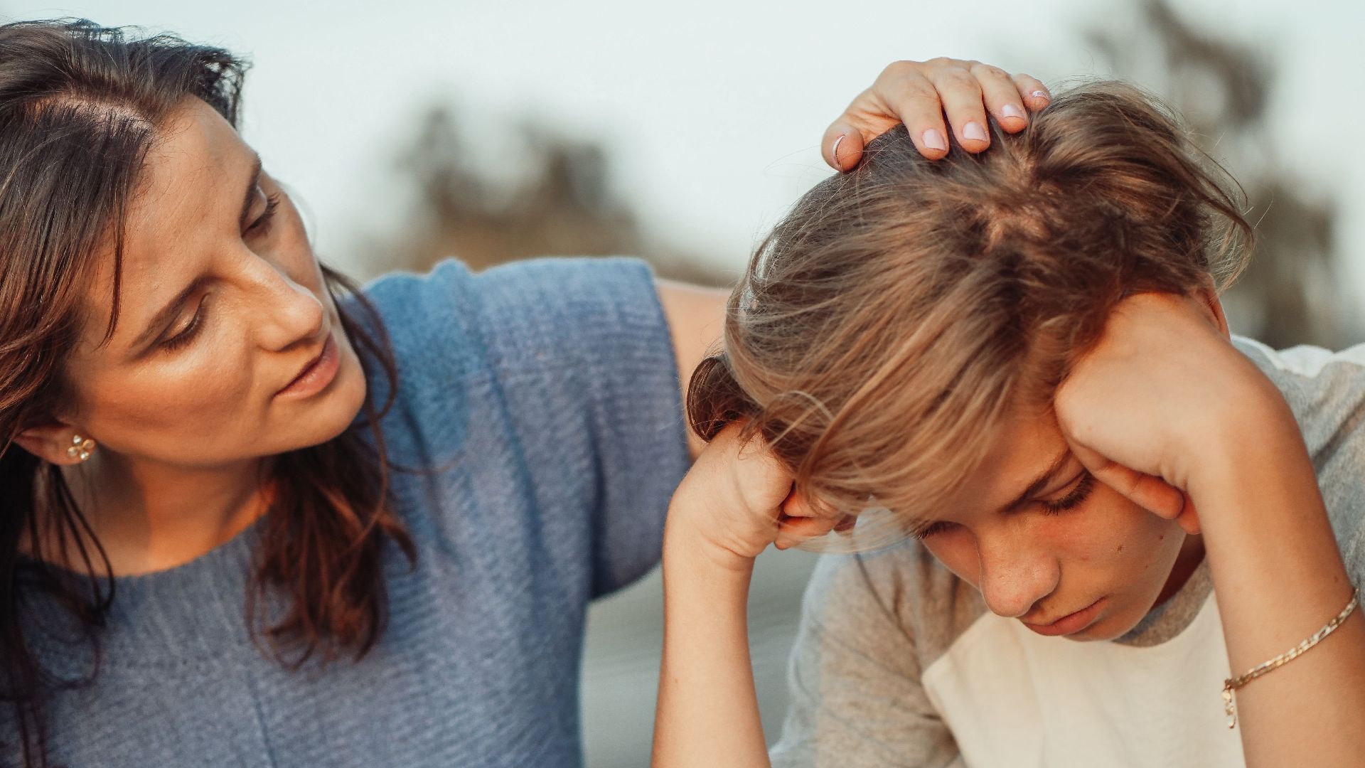A mother offers support to her discouraged teenager son, portraying love and understanding.