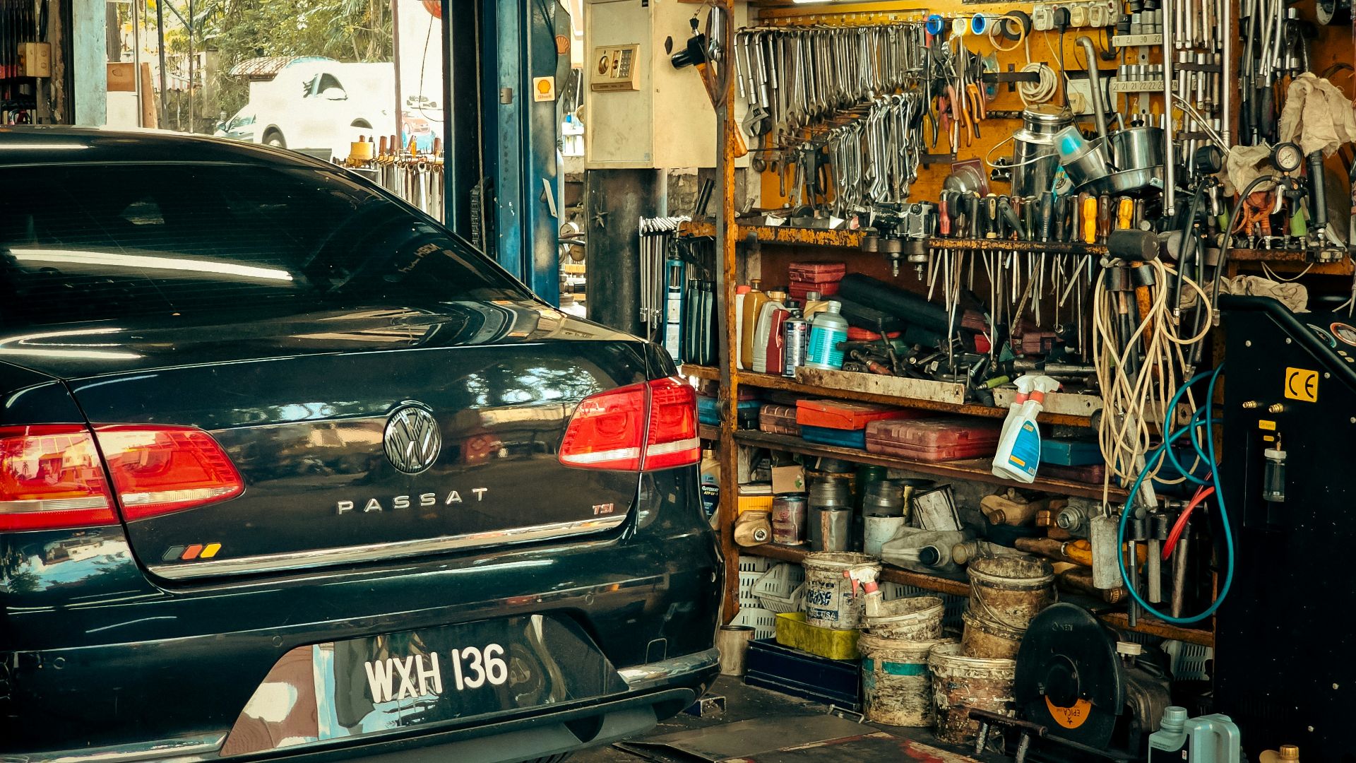 A car parked in front of a store filled with items