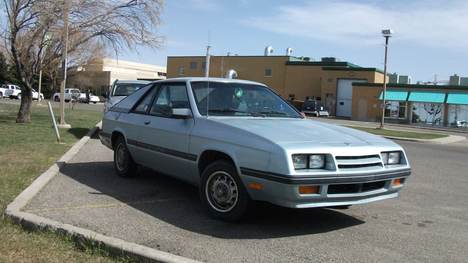 An 1986 or 1987 Plymouth Turismo

I learned to drive on an almost identical Plymouth Turismo. The dash was swapped in from a Charger at some point. Ours was a 1986 version but eventually developed a blown headgasket or coolant leak (didn't know much about