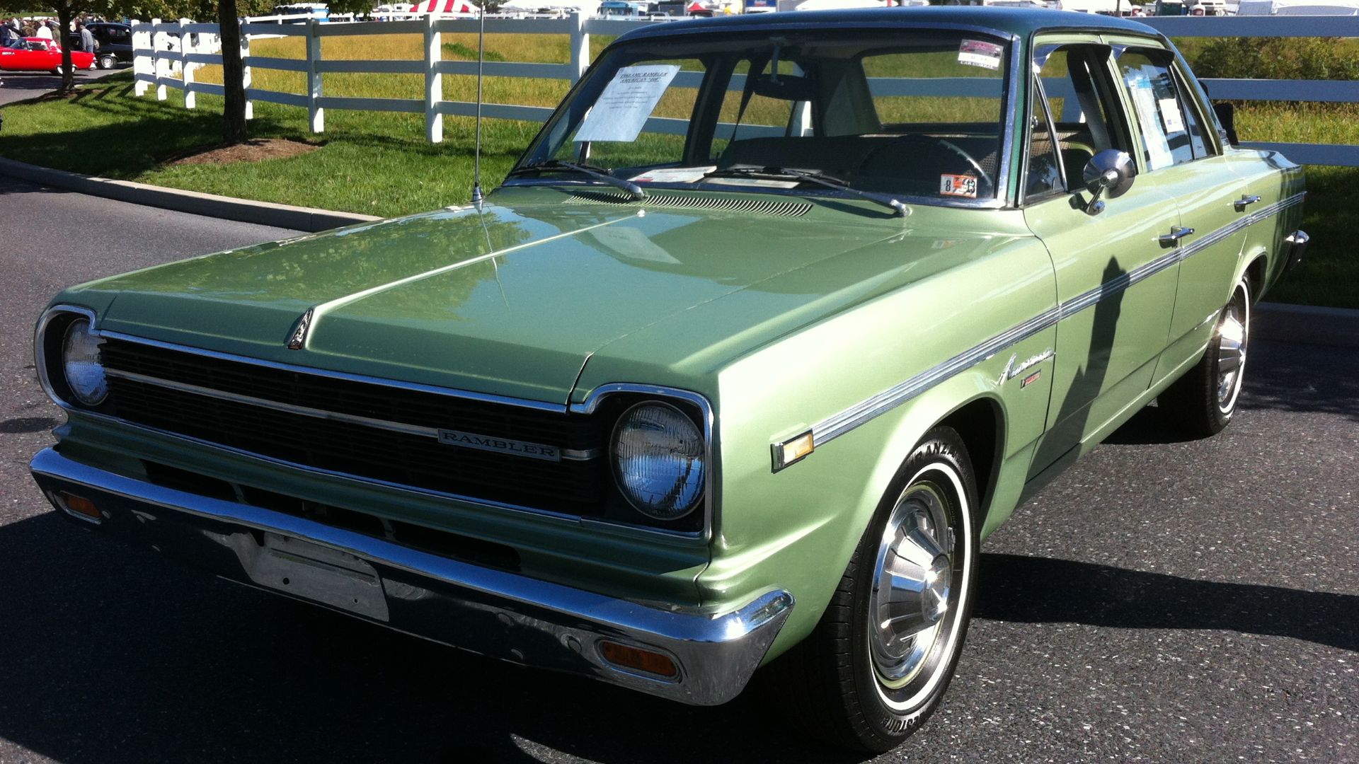 1968 Rambler American - built by American Motors Corporation (AMC). Front view of four-door sedan in the 440 model, finished in two-tone green with matching interior. Picture taken on the automobile sales field of the Antique Automobile Club of America (A