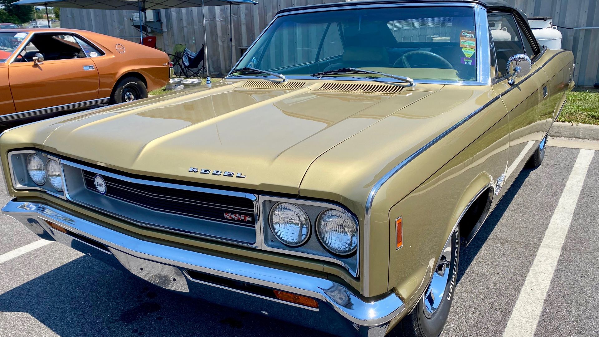 1968 AMC Rebel convertible AMO 2024 meet finished in Scarab Gold (paint code P52A) with matching interior (individually adjustable and reeling front seats were standard) and the soft top in black. The 1968 model year offered two convertible versions in th