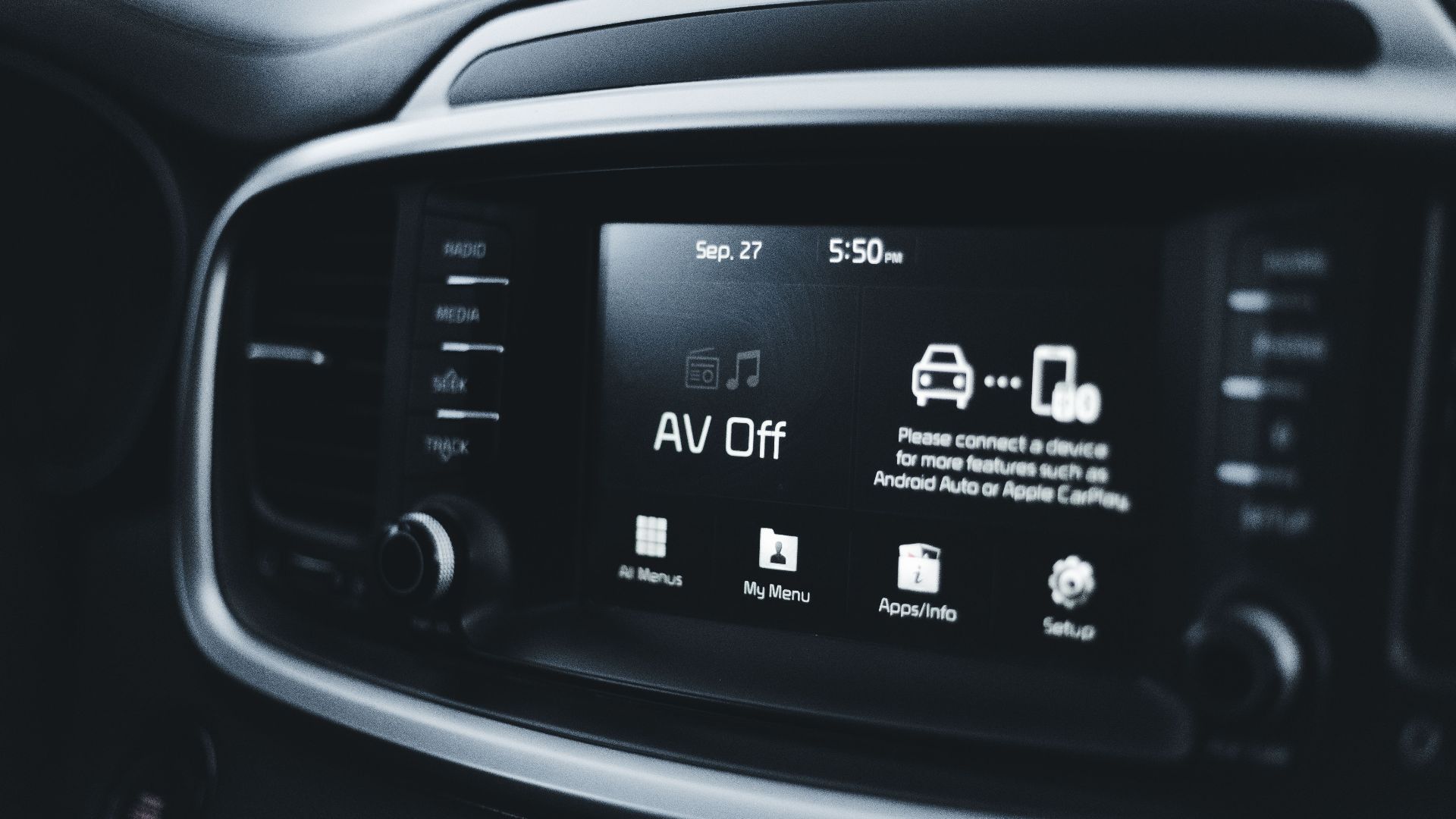 Detailed close-up of a modern car dashboard screen displaying various tech options and settings.