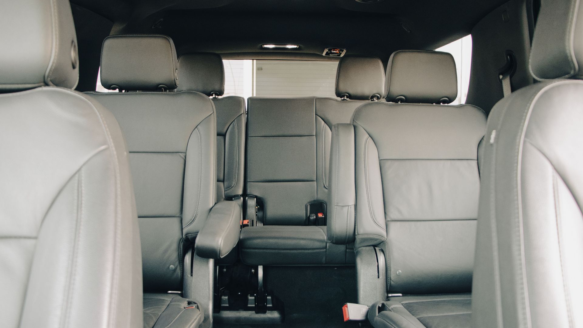 Explore the luxurious empty leather seats of a modern car interior, showcasing spacious design and comfort.