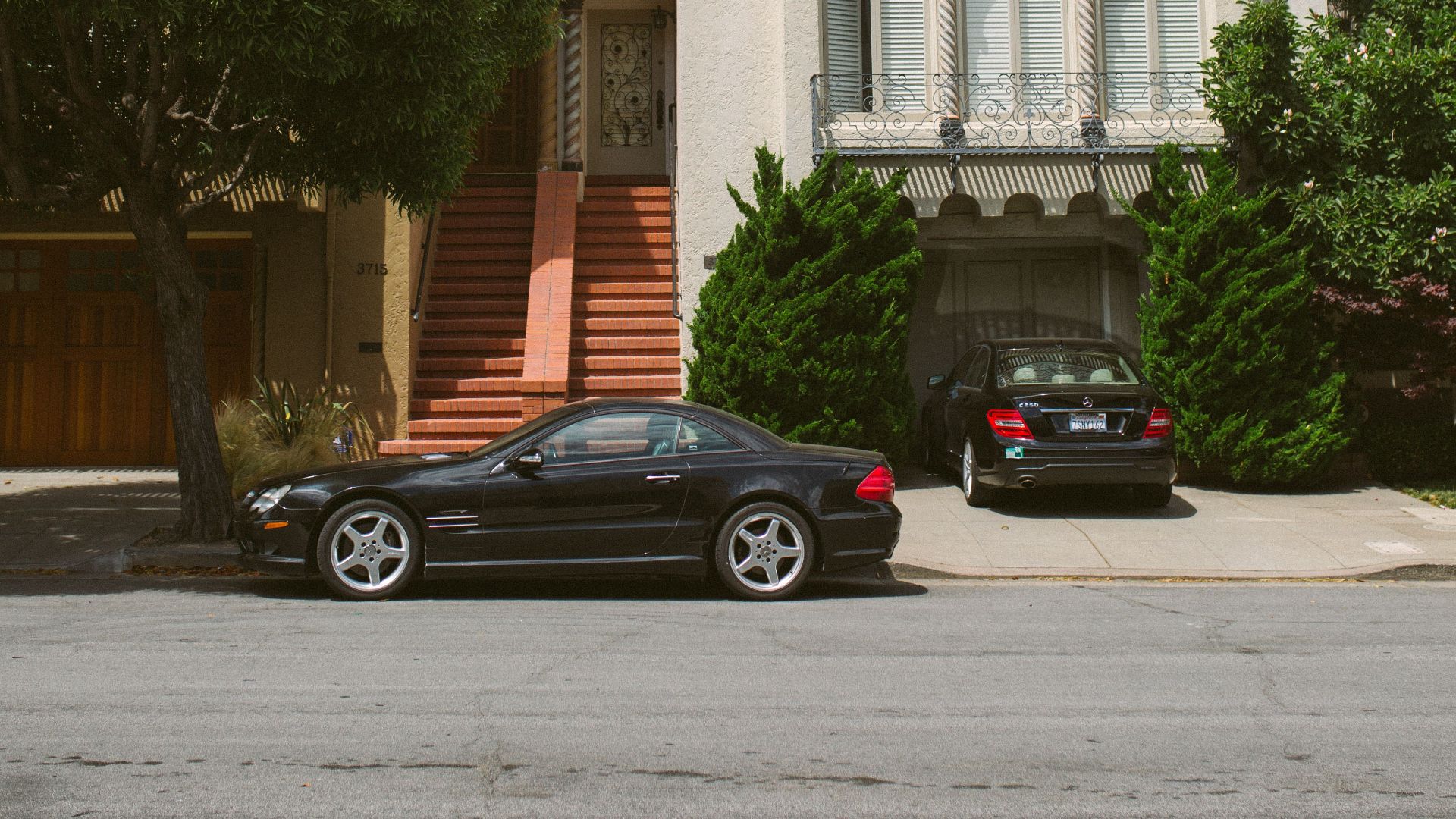 Beautiful residential architecture with parked cars in sunny San Francisco.