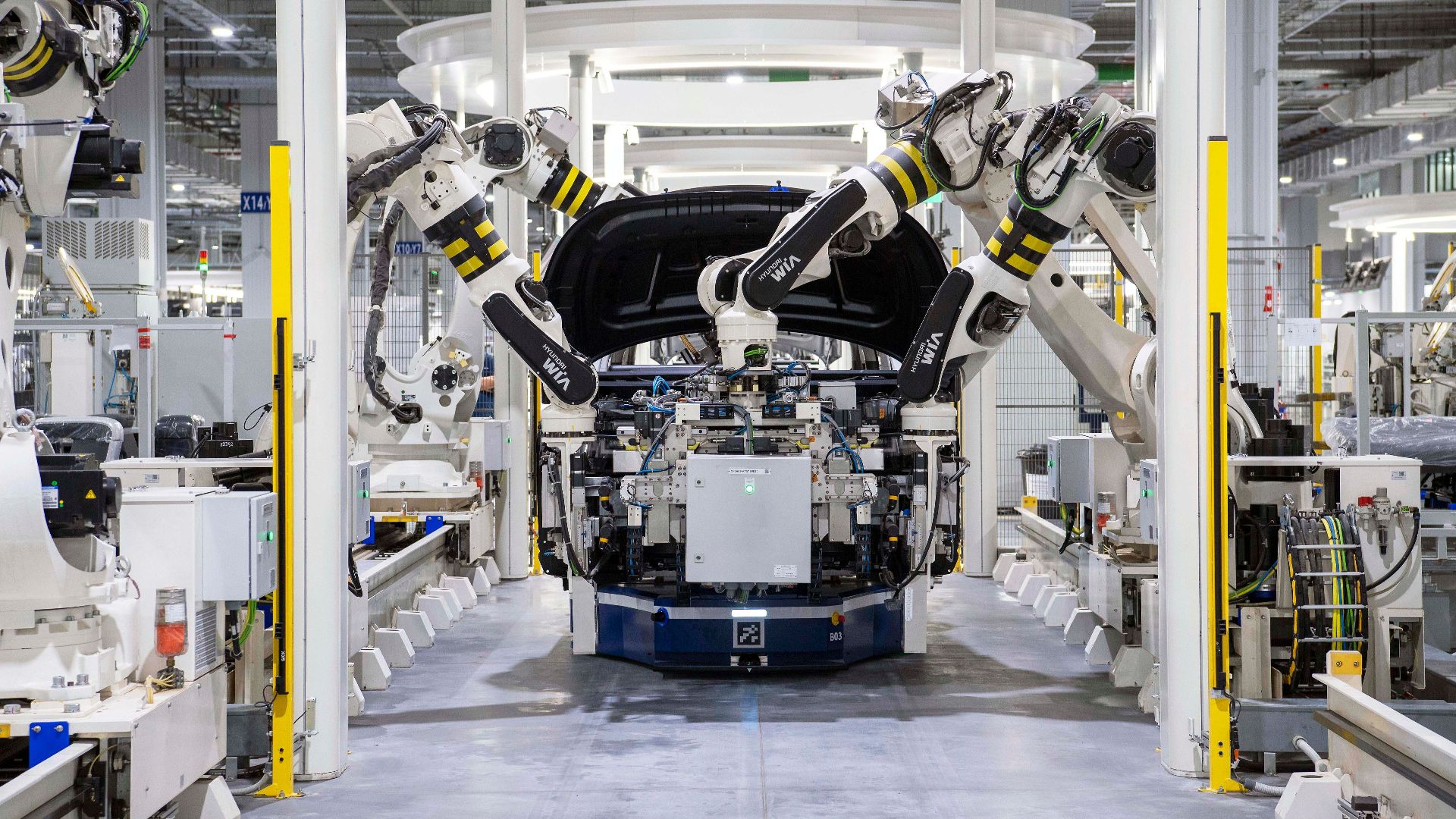High-tech robots assembling a car in a modern factory setting, showcasing automation.