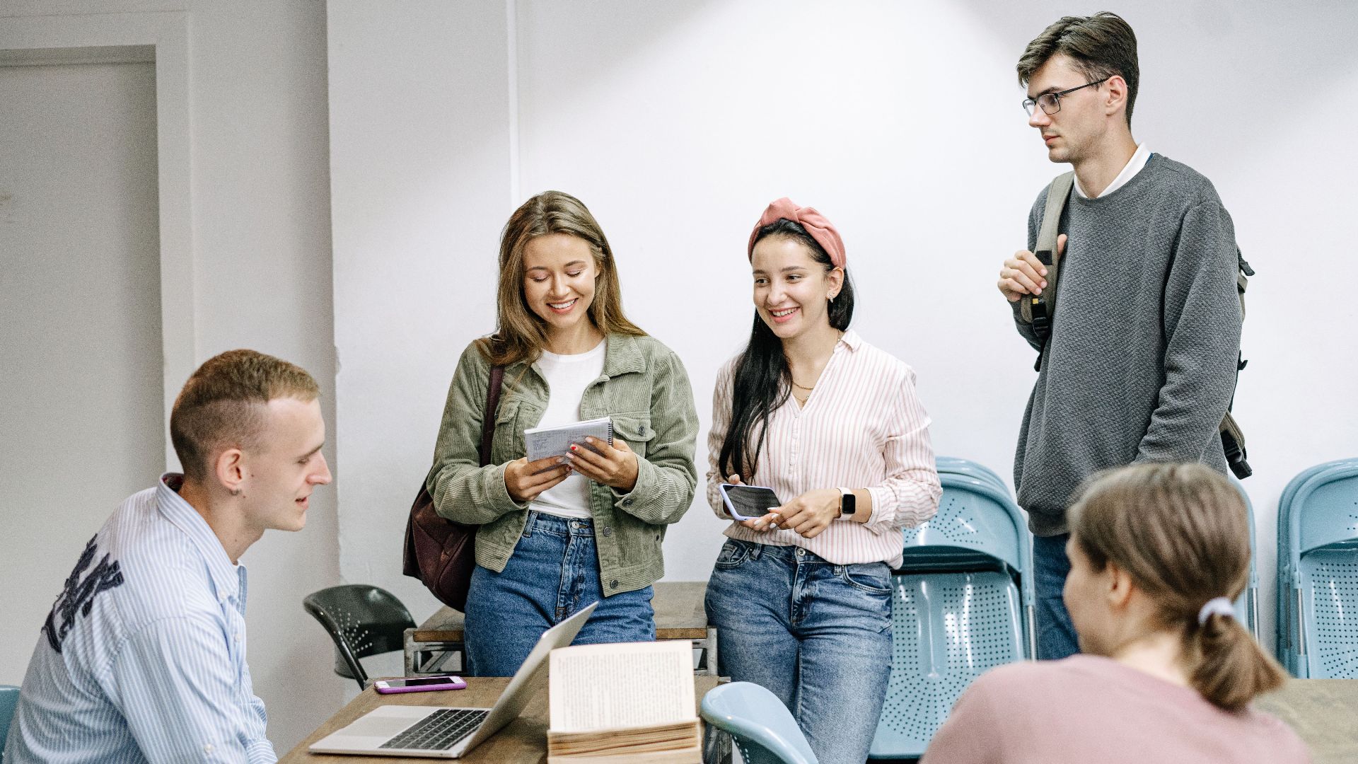 A diverse group of college students engaging in a lively study session indoors.