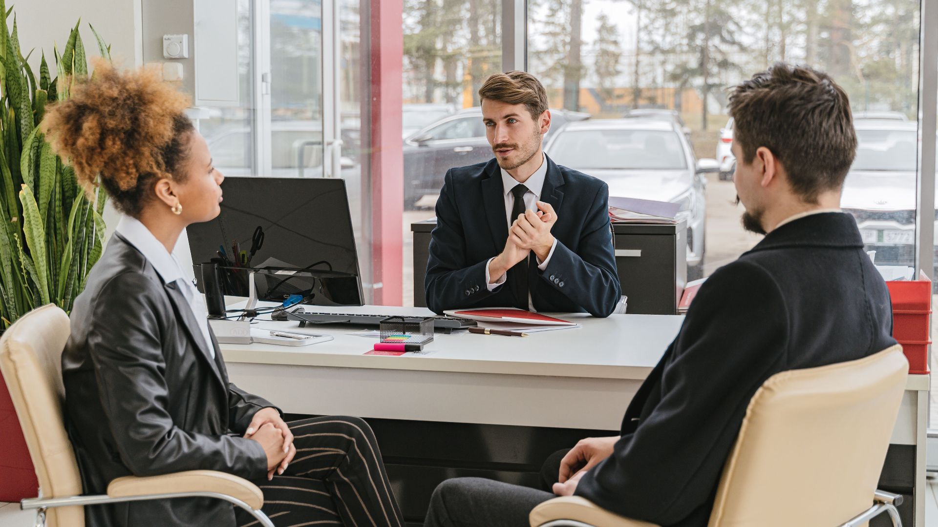 Professional meeting with clients at a modern office, discussing business solutions.