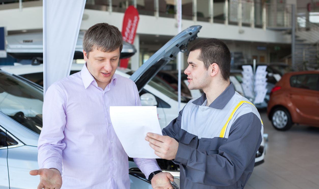 An angry customer talking to a mechanic in an auto repair shop