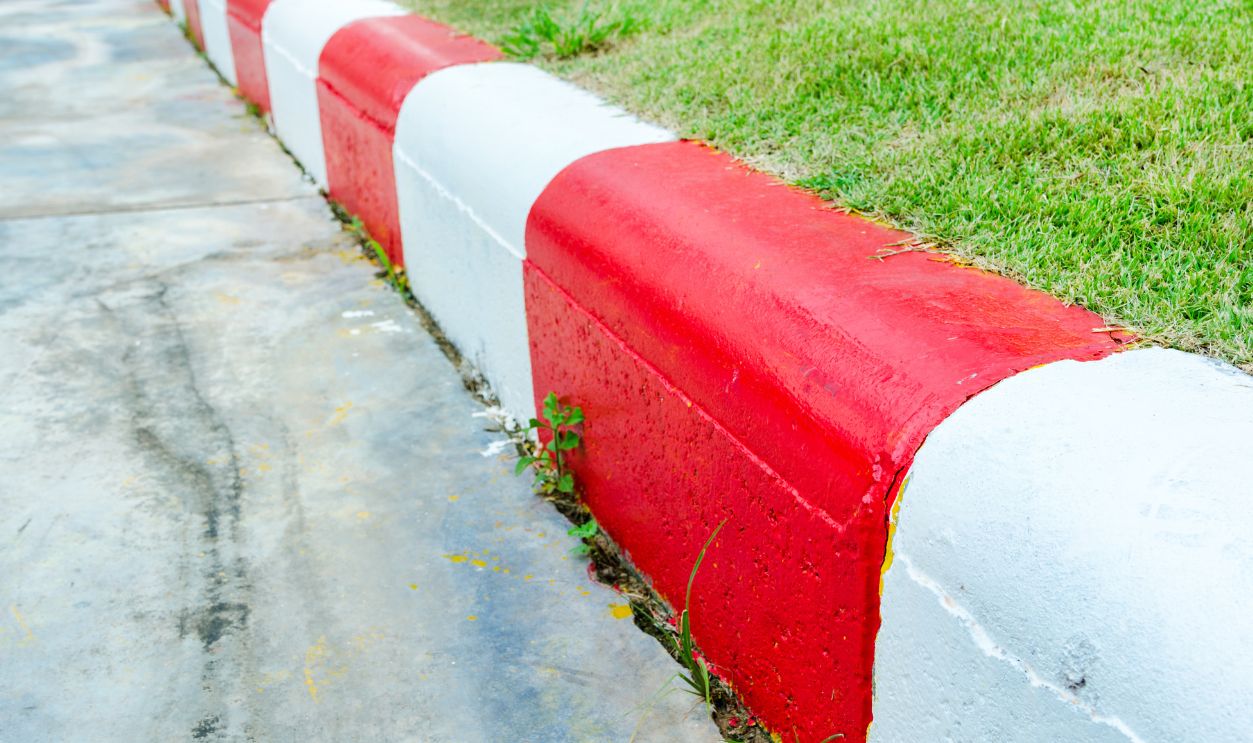 Red and White sign on the sidewalk background, no parking.