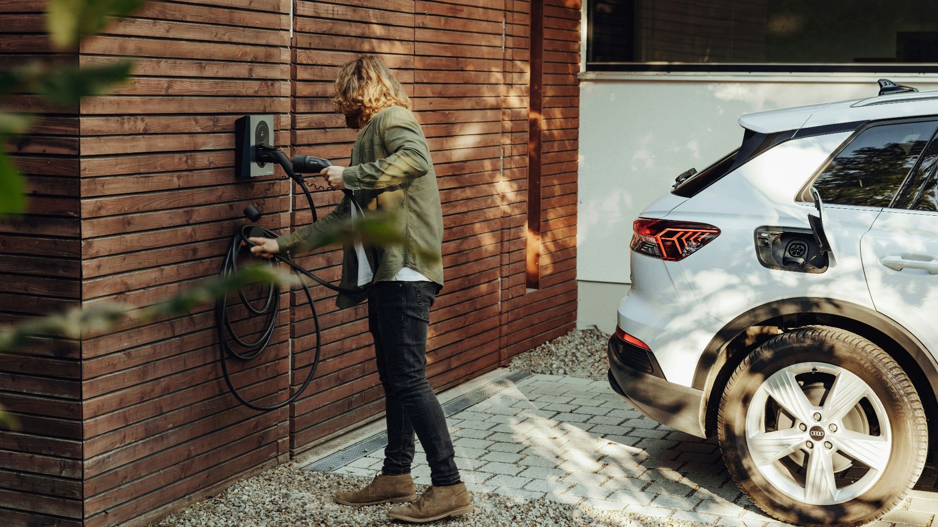 a woman is using a power washer on a brick wall