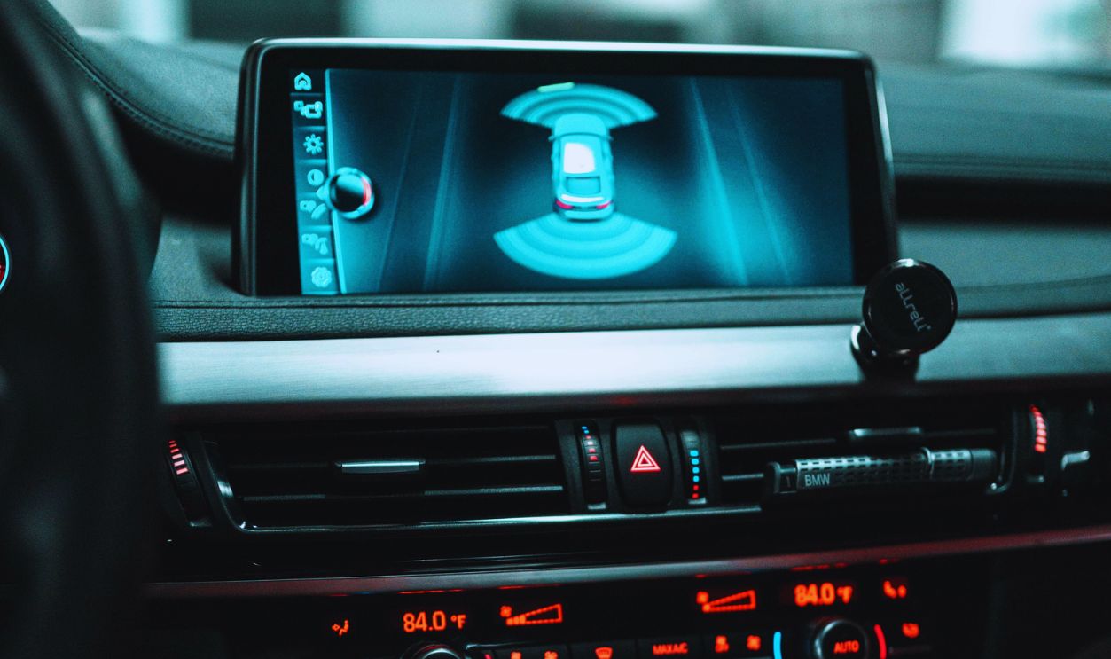 Close-up of a car dashboard with a digital screen and controls