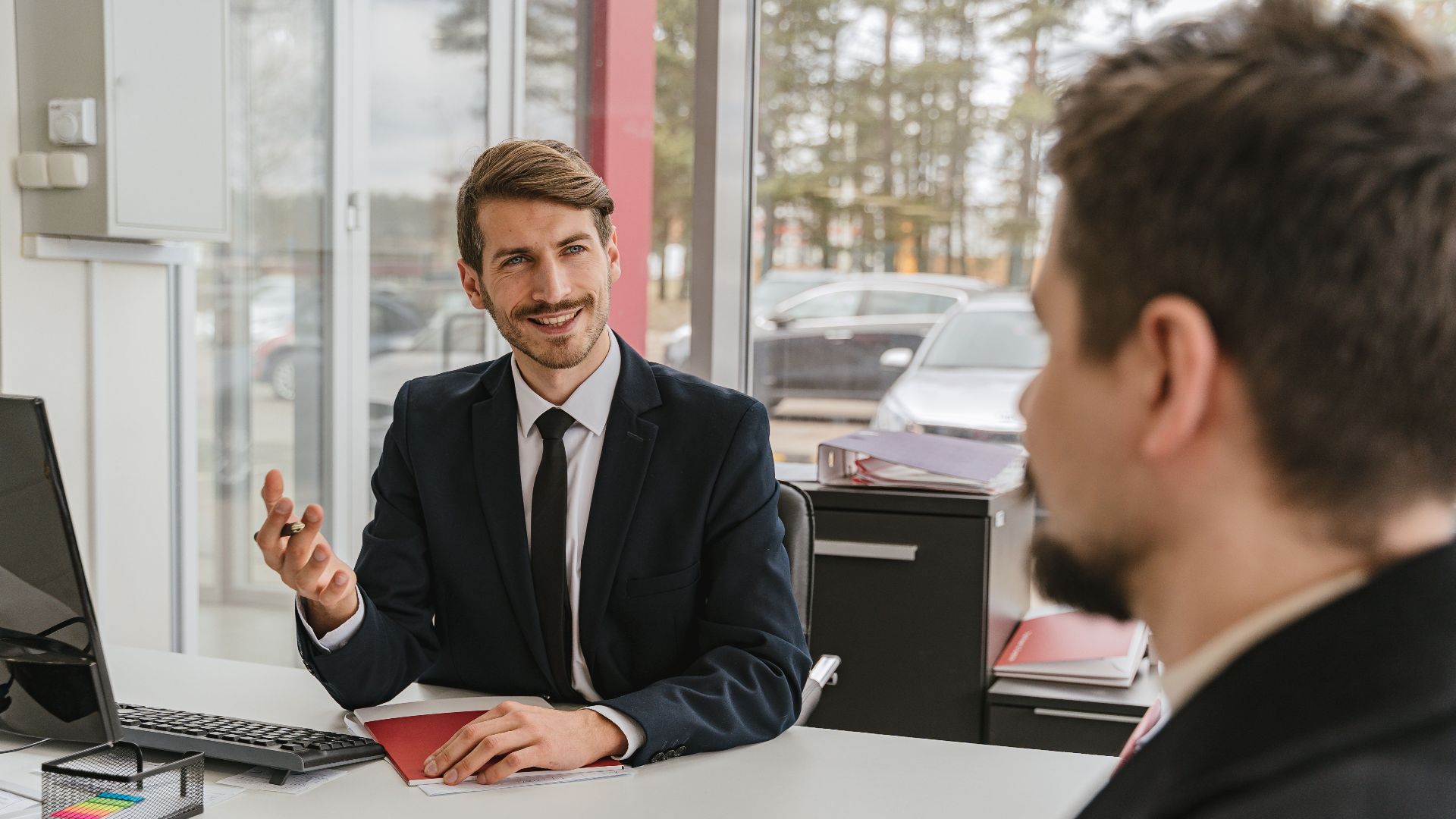 Two businessmen having a conversation in a modern office setting.