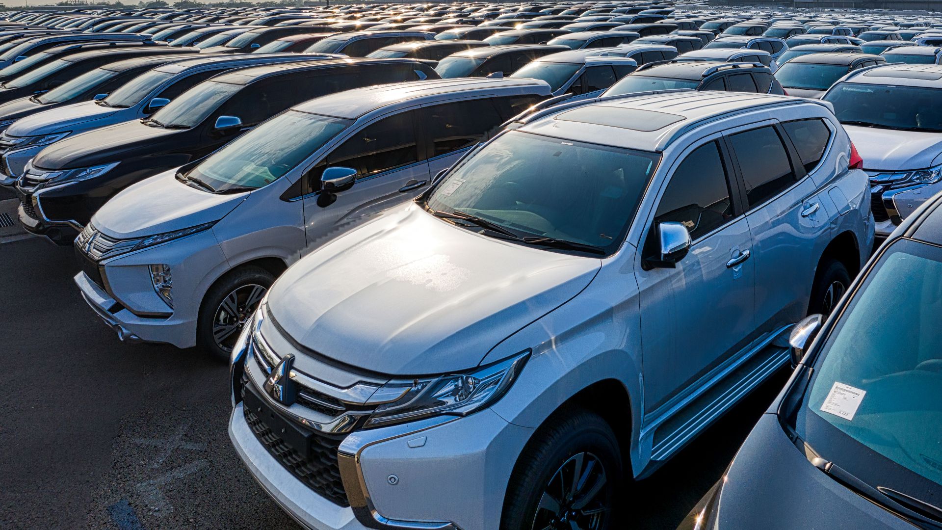 Modern prestige shiny cars in rows on asphalt parking of contemporary manufacture in daytime