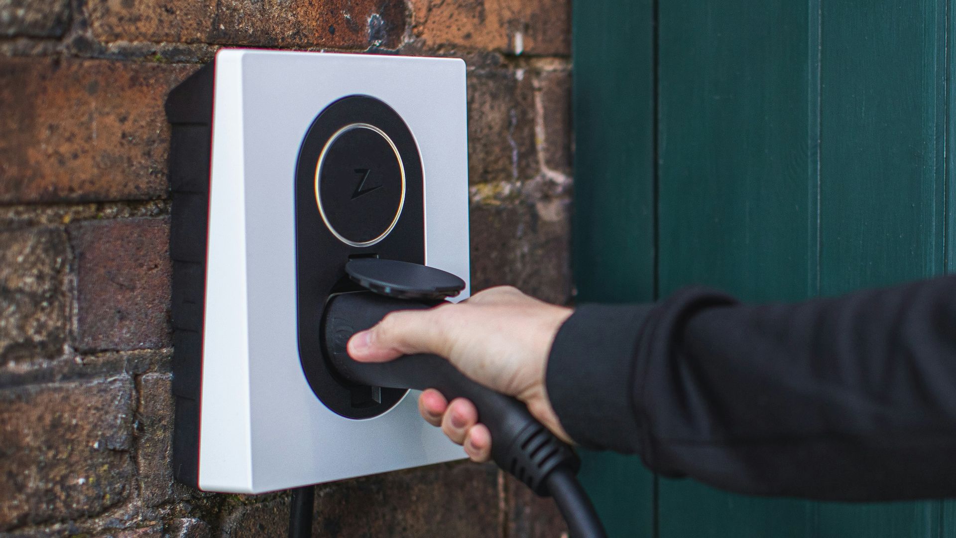 a person is plugging in to a wall mounted device
