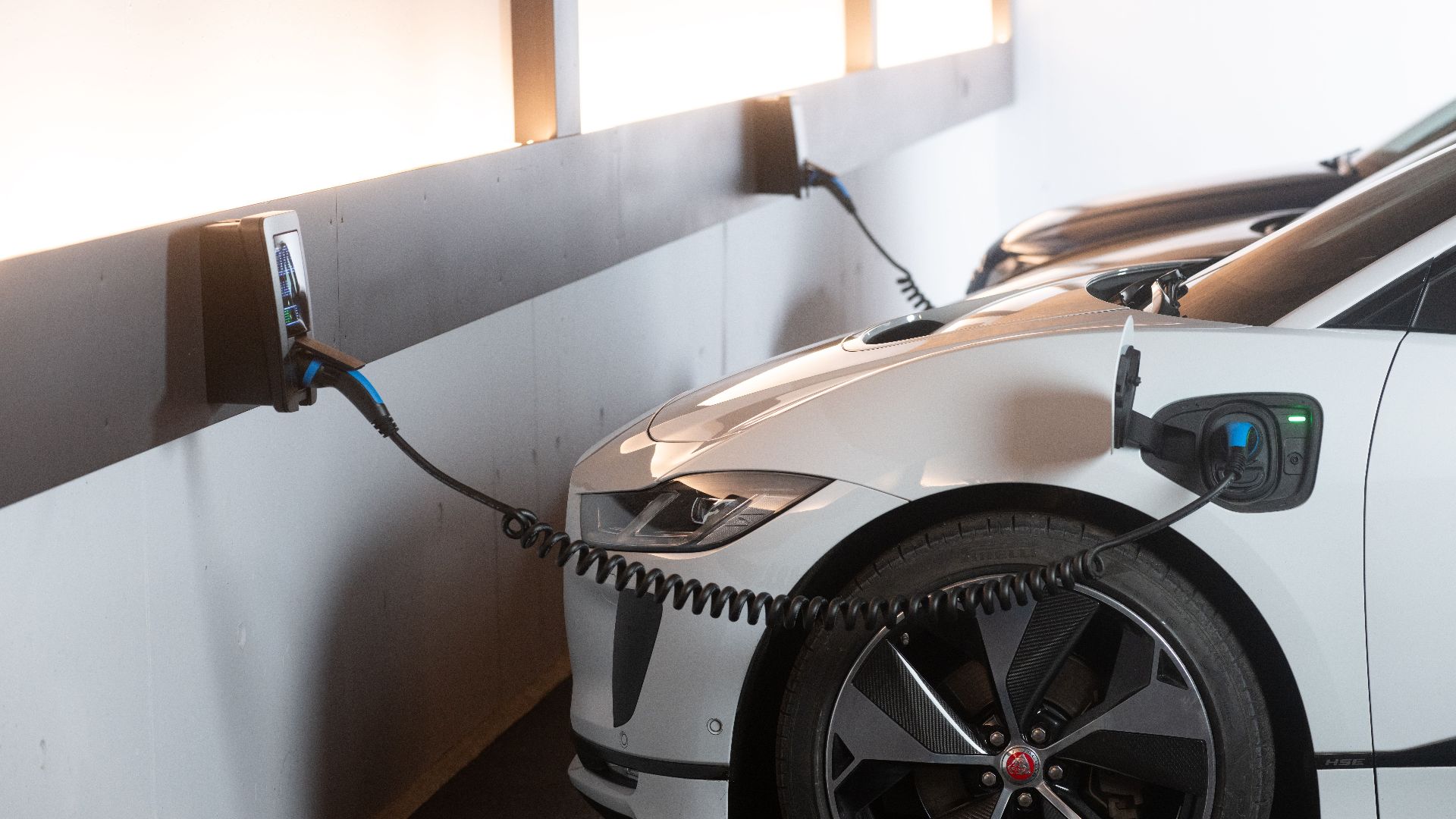 Electric car charging in a modern indoor station promoting sustainability and energy efficiency.