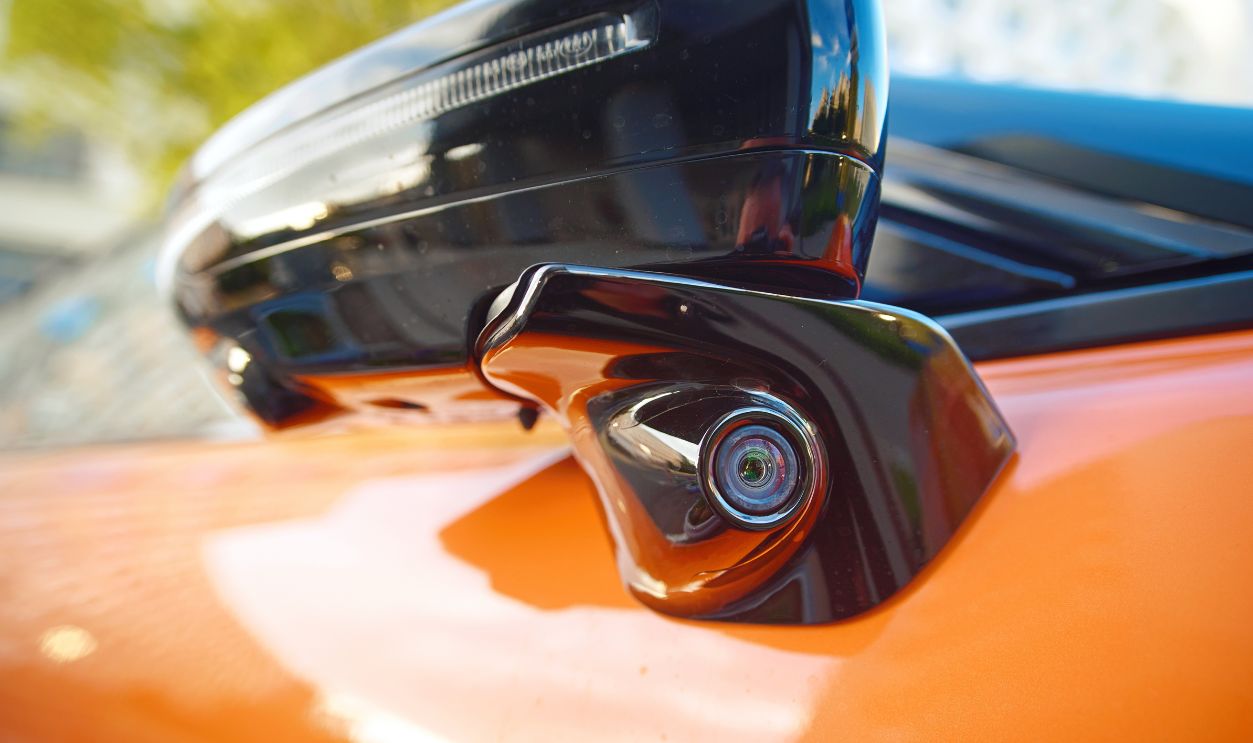 Car advanced side view camera system integrated into the door side mirror, enhanced blind spot detection and rear visibility. Car side mirror with blind spot monitoring closeup