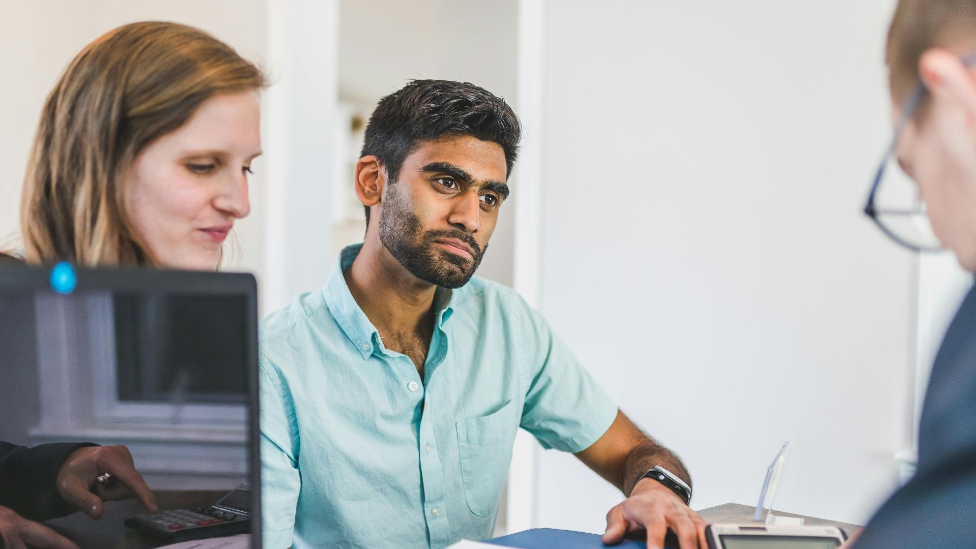 Diverse team discussing business strategies in a modern office setting.