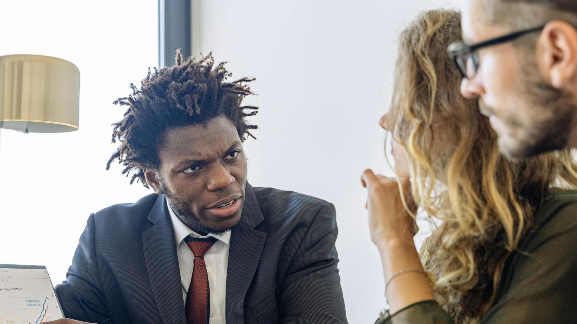 Business professionals discussing financial data during a collaborative meeting.
