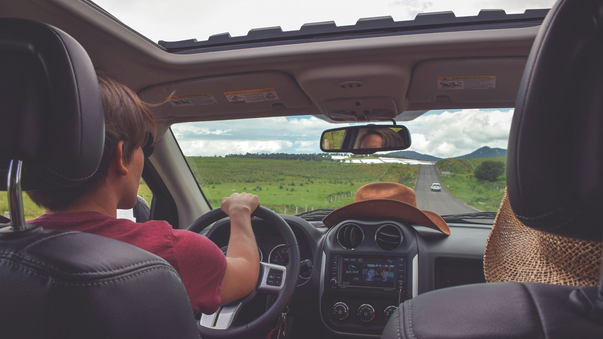 man driving straight on pathway during day time
