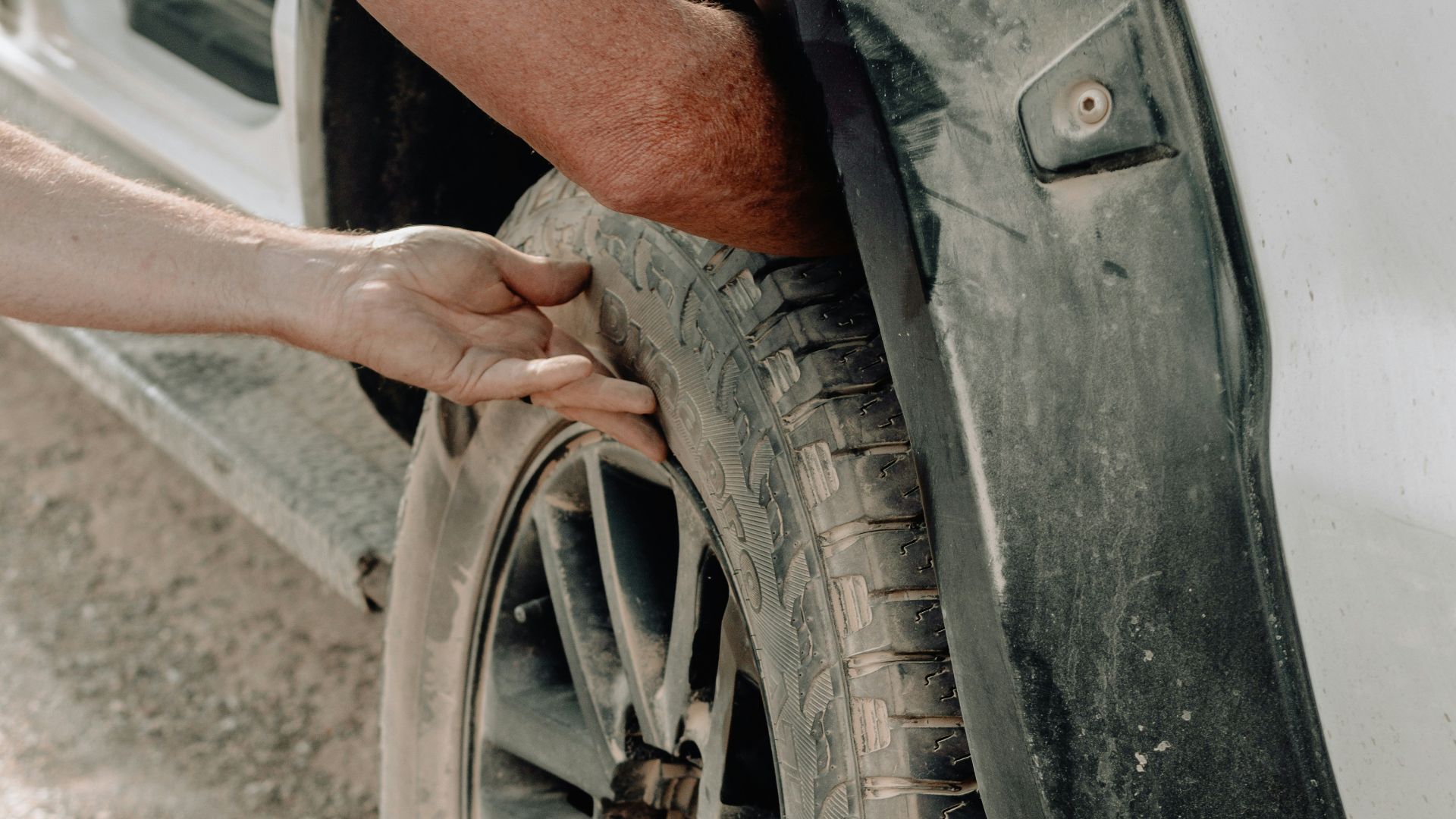 person put the wheel on the vehicle