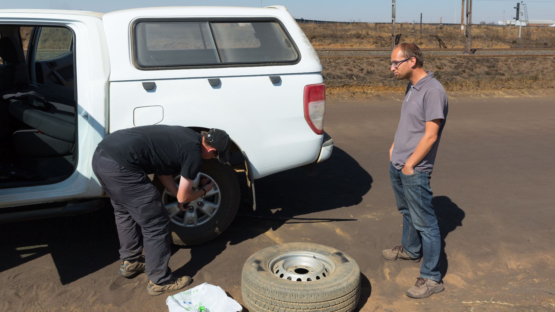 Changing the wheel on our colleague's Ford Ranger. Chasing trains in South Africa for three weeks using two cars (a Ford Ranger and a Toyota Hilux) took its toll. One flat (pictured) and a broken mirror (duct tape for the win!) on the Ranger, three (!) fl