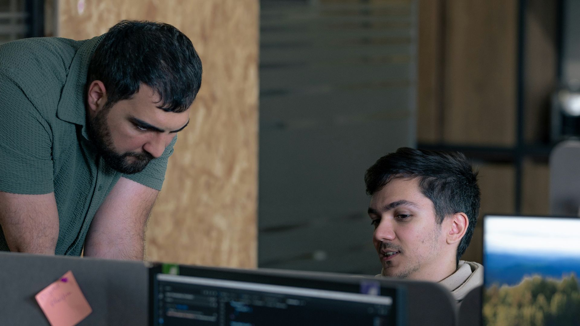 Two men working on computers in an office
