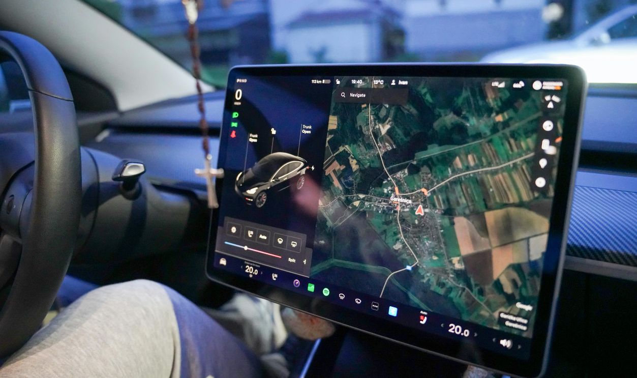 Close-up of a car's digital dashboard displaying GPS navigation in Garesnica, Croatia