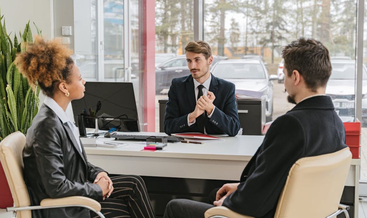 Professional meeting with clients at a modern office, discussing business solutions