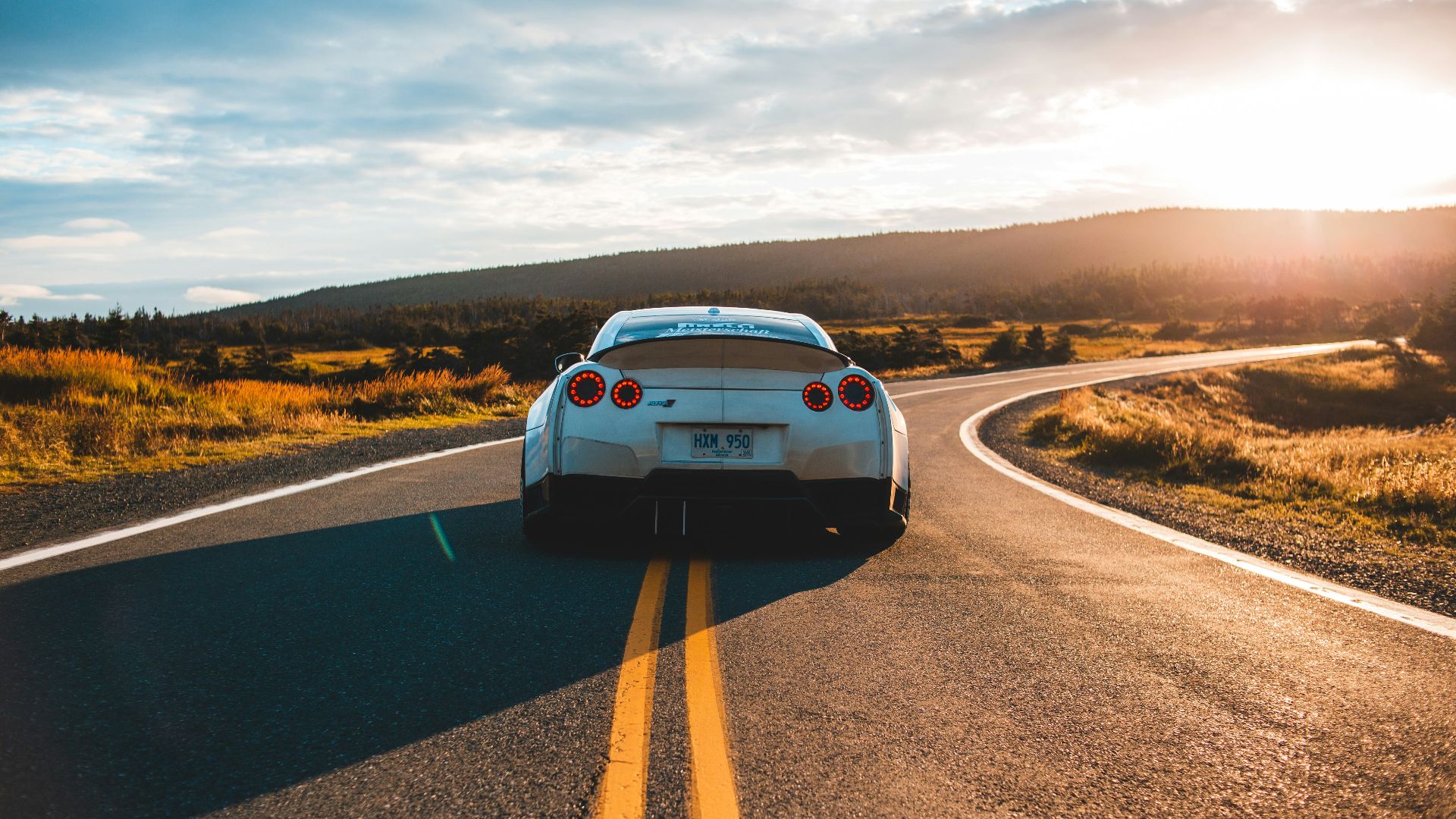 silver sports coupe on asphalt road