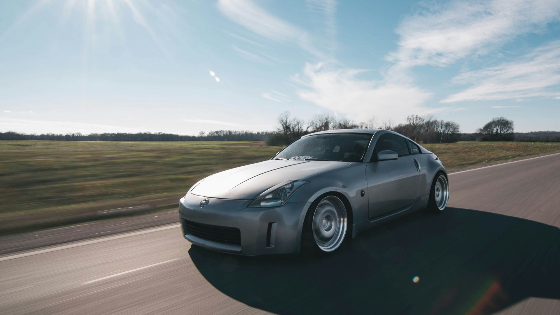 photo of gray coupe on road at daytime