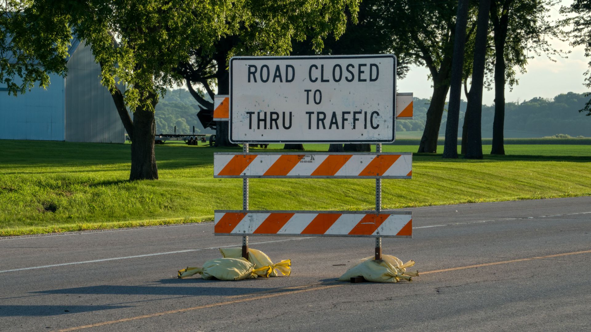 A road closure sign blocks traffic on a rural road in Plainview, Minnesota.
