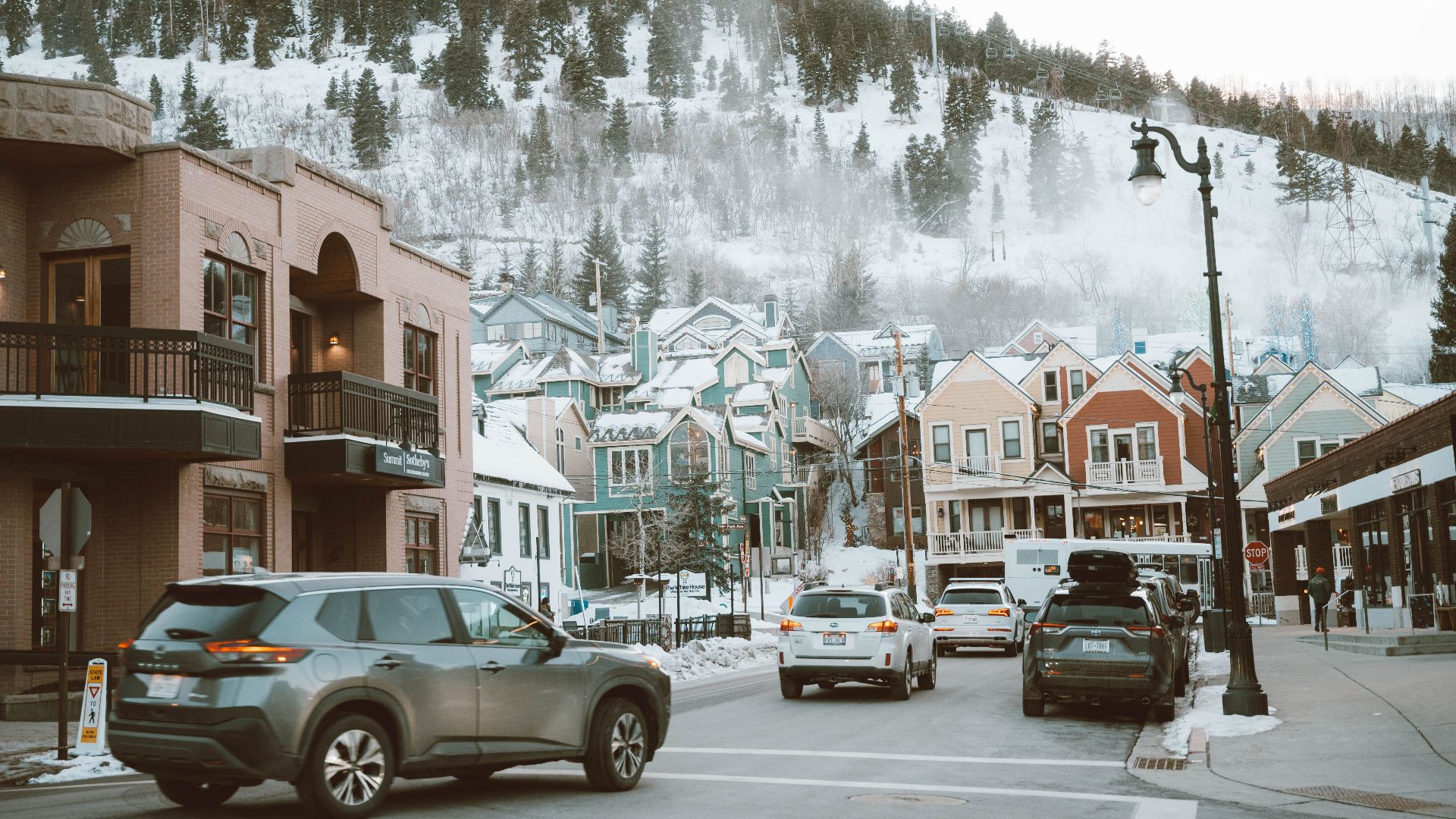 Charming winter street with colorful houses and cars in Park City, Utah.