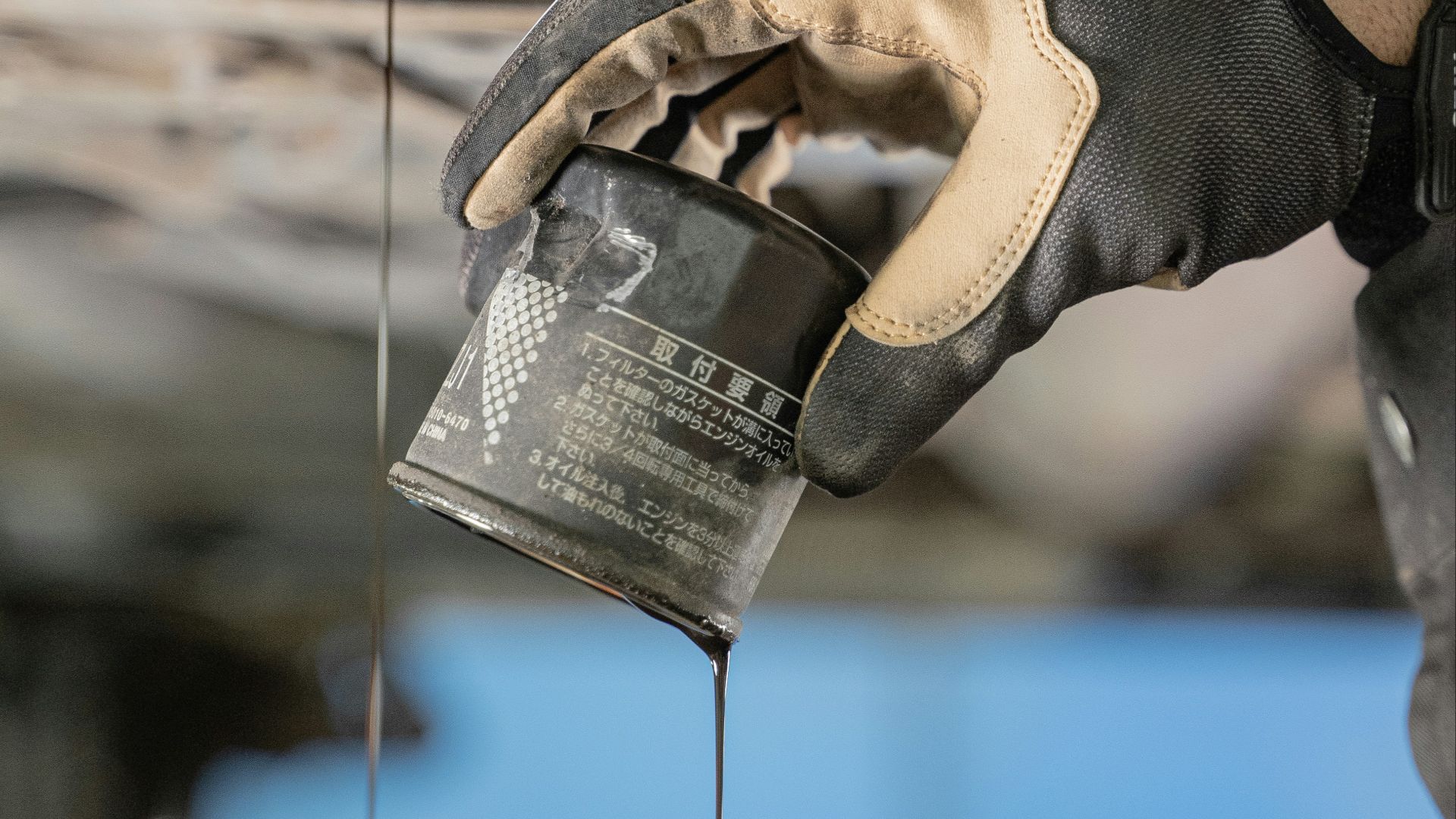 a mechanic is pouring oil on a car