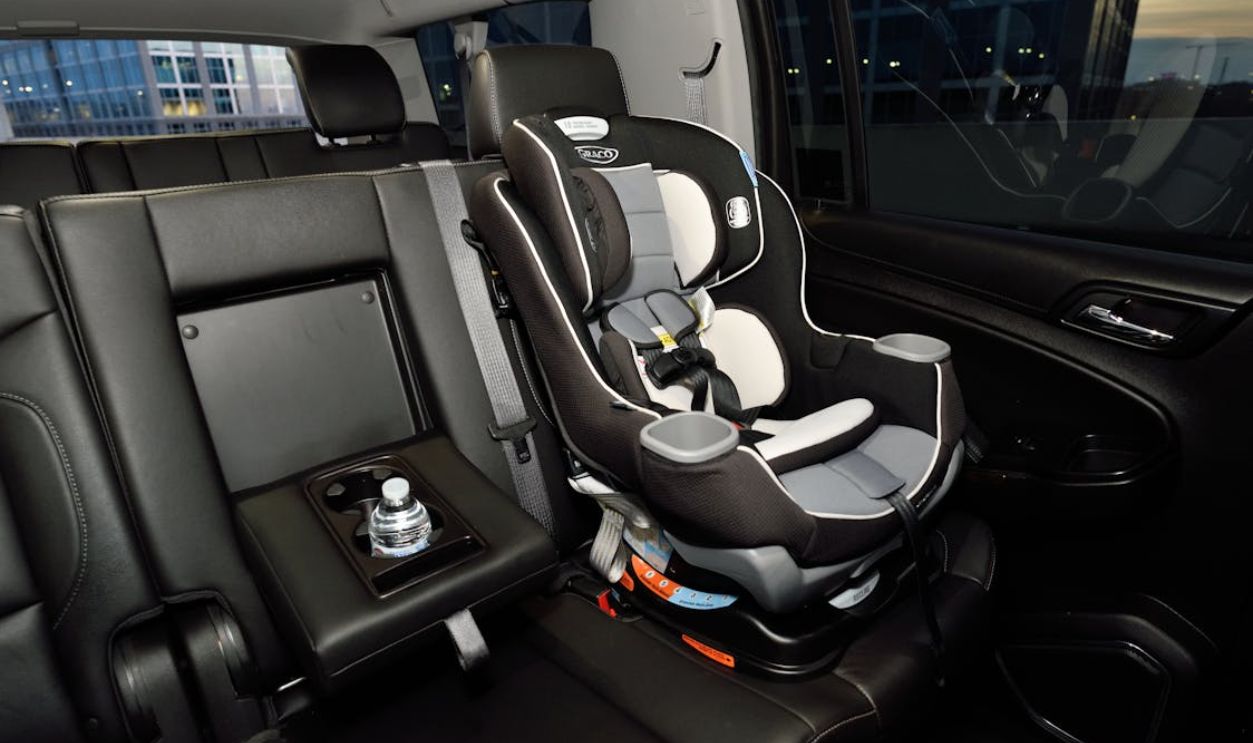 Safety car seat securely installed in the back of a modern vehicle. Ideal for family travel.