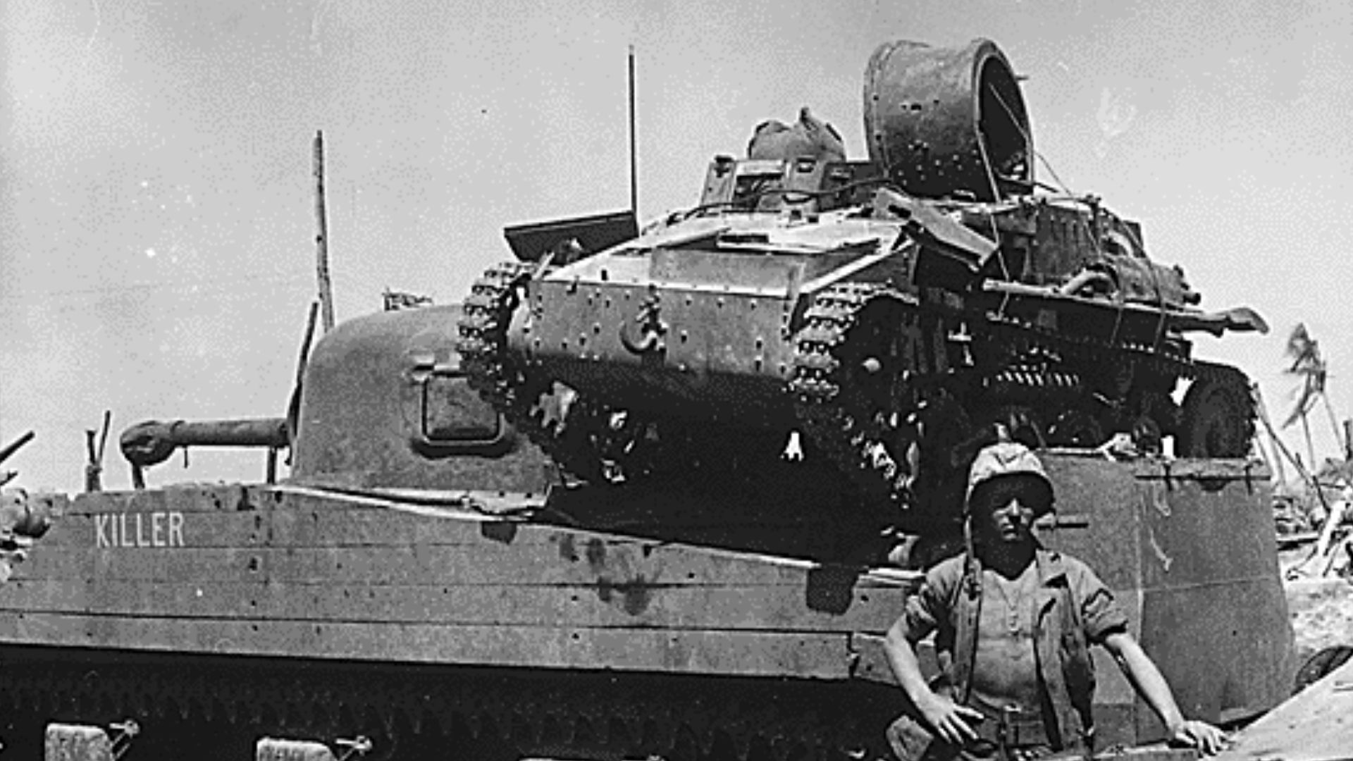Kwajalein Atoll. Private First Class N. E. Carling stands beside the American M4 Sherman medium tank