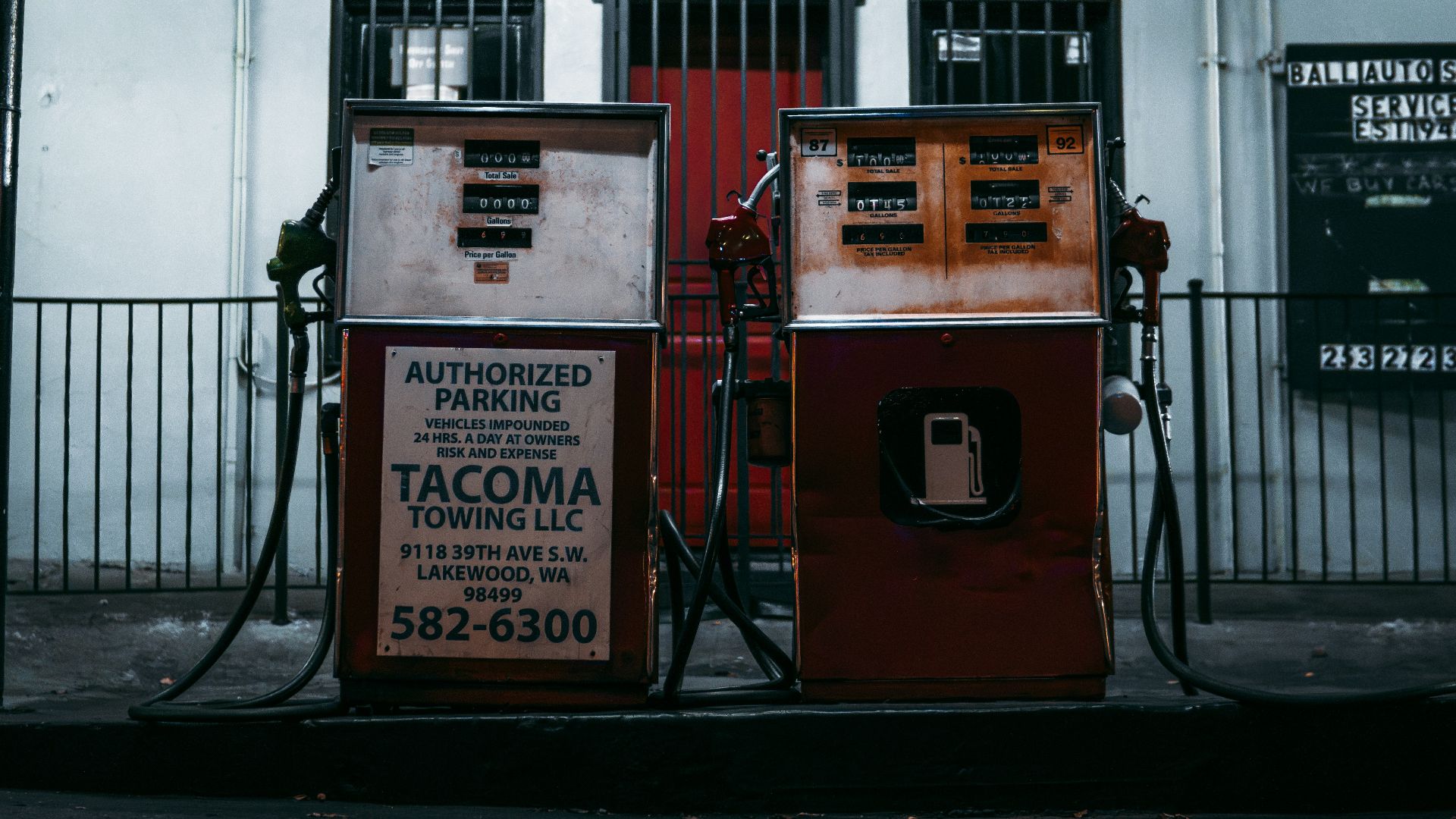 An old fashioned telephone booth in front of a building