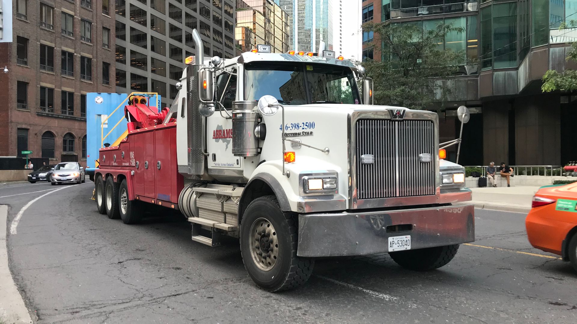 A Western Star truck (Ontario license plate AP 53040) with Abrams Towing Services using a Vulcan car carrier.