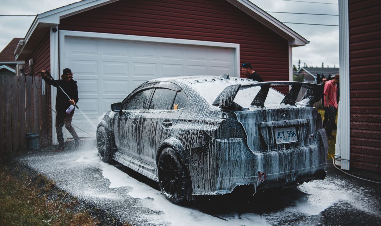 Outdoors car washing scene with a sports car