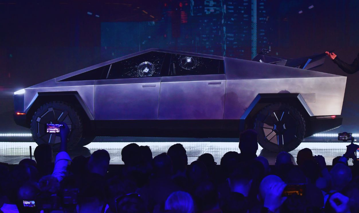 Gettyimages - 1183832732, US-AUTOMOBILE-TESLA-CYBERTRUCK Tesla co-founder and CEO Elon Musk speaks in front of the newly unveiled all-electric battery-powered Tesla's Cybertruck with shattered windows, after a failed resistance test, at Tesla Design Center in Hawthorne, California on November 21, 2019. 