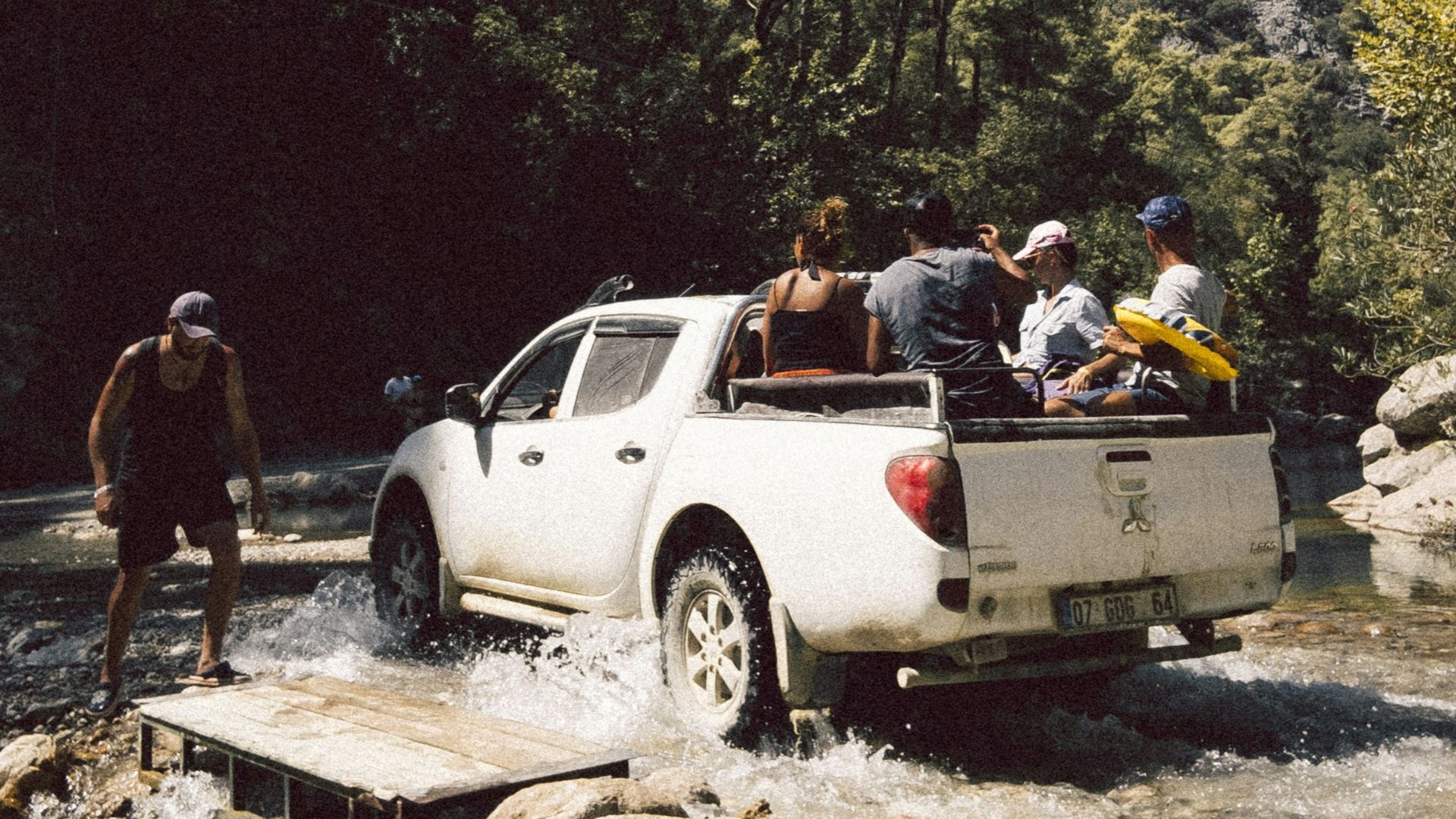 people standing beside white crew cab pickup truck during daytime