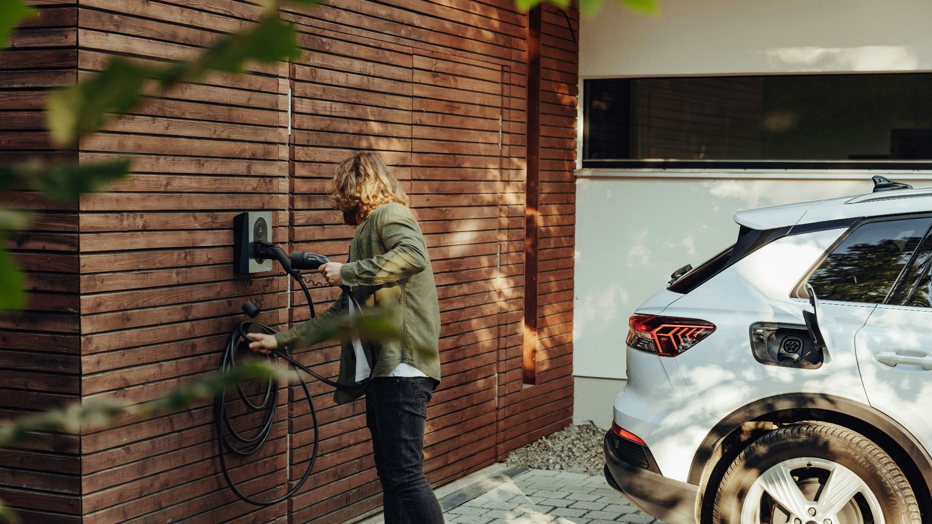 a woman is using a power washer on a brick wall